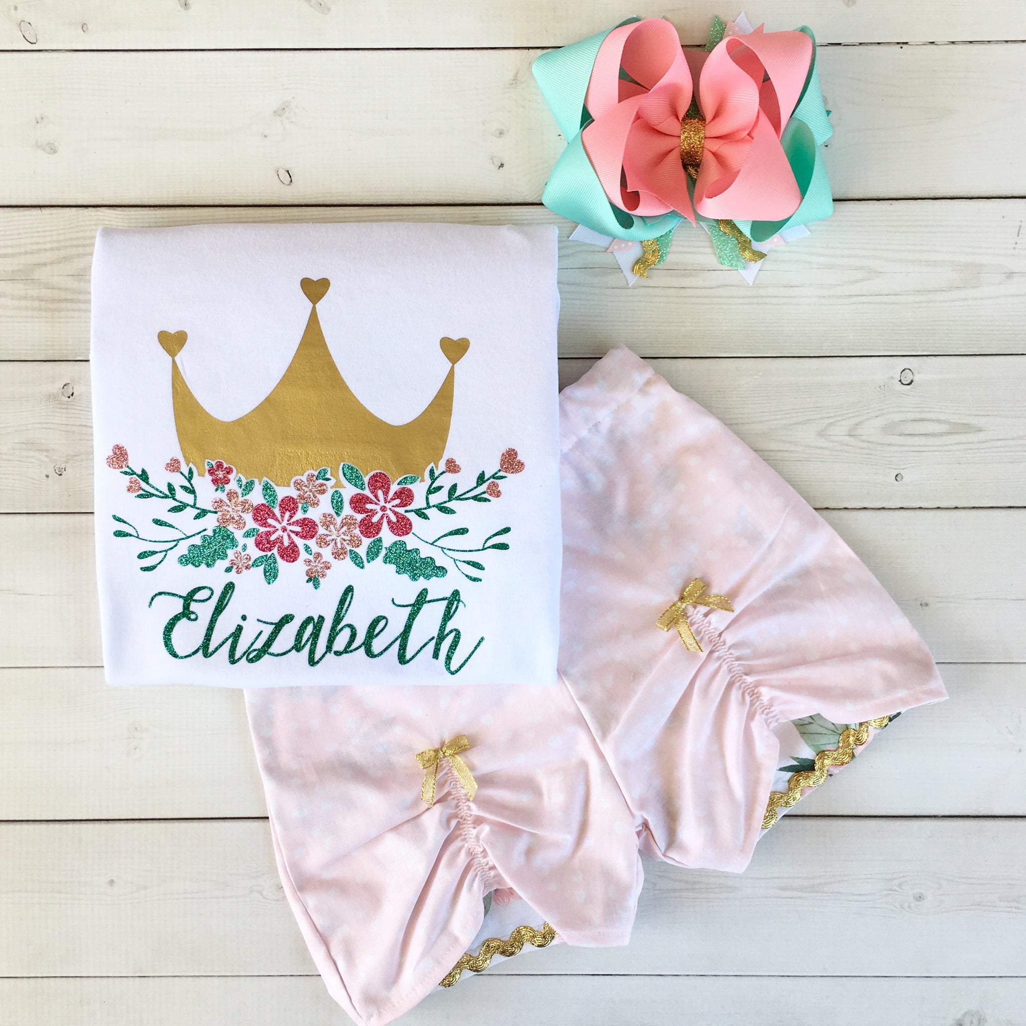 Gorgeous princess outfit for girls, toddlers and babies. Gold crown covered in glitter pink flowers customized with full name. Pink petal custom shorts with gold bowsare perfection!