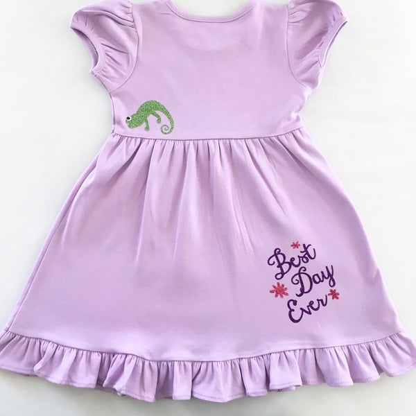 Disney dresses for girls toddlers babies. Tangled Inspired, Rapunzel inspired disney dress for girls on lavender dress with personalized glitter monogram on bodice and fully decorated skirt with best day ever and matching bow