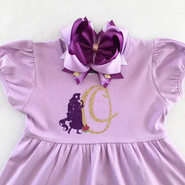 Disney dresses for girls toddlers babies. Tangled Inspired, Rapunzel inspired disney dress for girls on lavender dress with personalized glitter monogram on bodice and fully decorated skirt with best day ever and matching bow