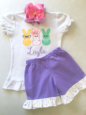 Girls easter outfit with shirt and ruffled shorts and easter bow. Shirt embroidered with three decorated bunnies inspired by Peeps! Lavender shorties finished with a confetti top ruffle.