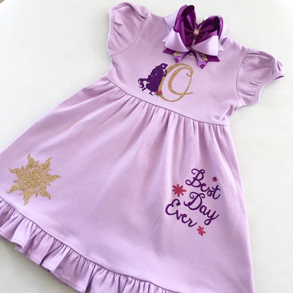 Disney dresses for girls toddlers babies. Tangled Inspired, Rapunzel inspired disney dress for girls on lavender dress with personalized glitter monogram on bodice and fully decorated skirt with best day ever and matching bow