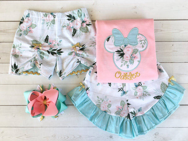 Gorgeous Disney outfit for girls, toddlers and babies. Minnie-like silhouette done in pretty floral fabir and aqua dot bow. Matching floral ruffled shorts are perfection!