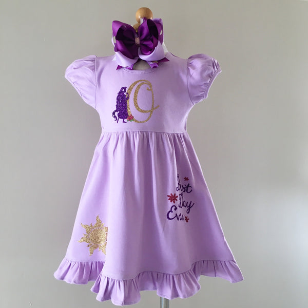 Disney dresses for girls toddlers babies. Tangled Inspired, Rapunzel inspired disney dress for girls on lavender dress with personalized glitter monogram on bodice and fully decorated skirt with best day ever and matching bow