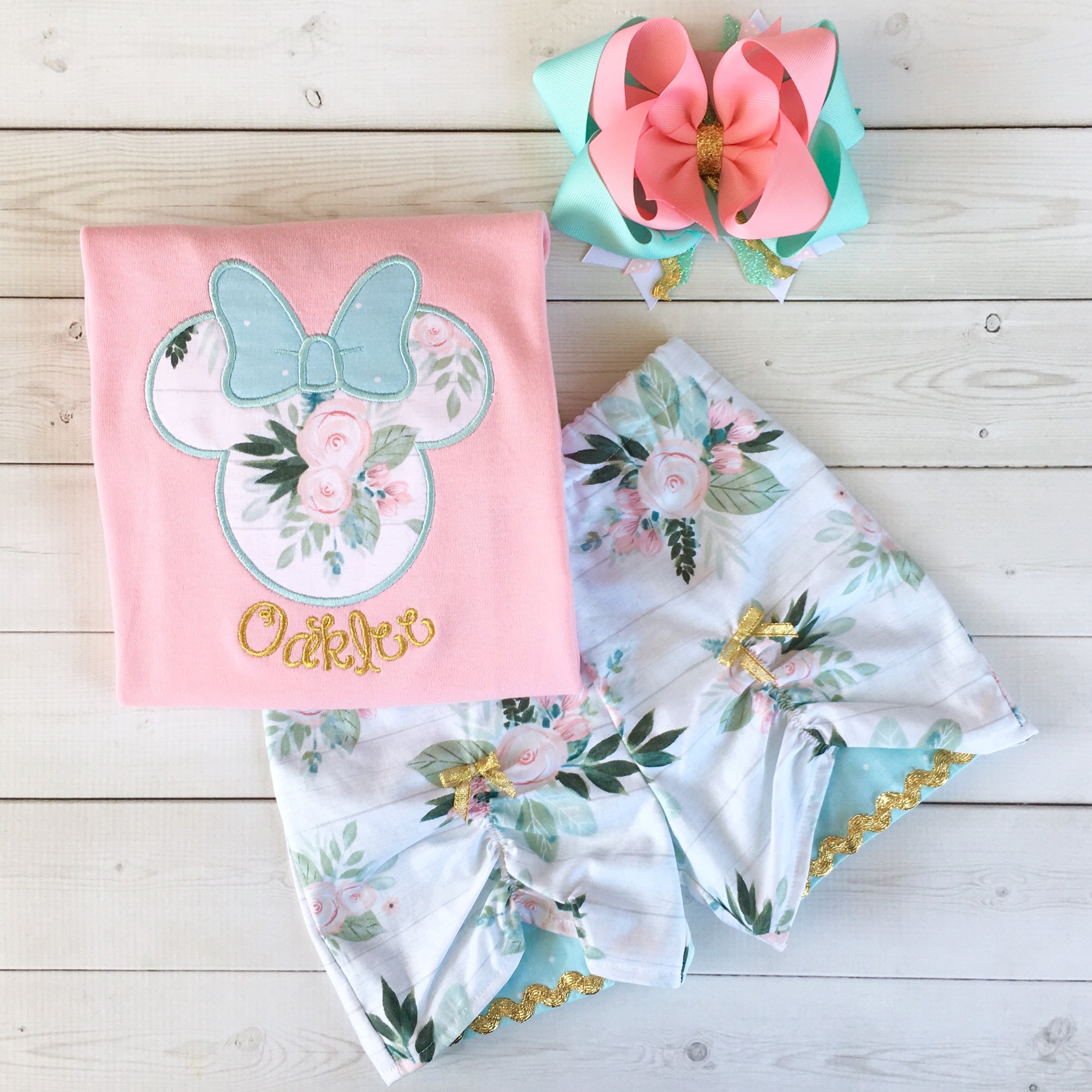 Gorgeous Disney outfit for girls, toddlers and babies. Minnie-like silhouette done in pretty floral fabir and aqua dot bow. Matching floral peek a boo shorts are perfection!