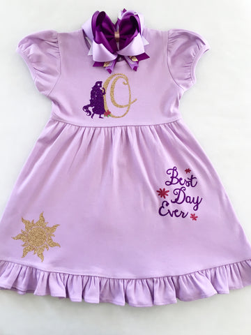 Disney dresses for girls toddlers babies. Tangled Inspired, Rapunzel inspired disney dress for girls on lavender dress with personalized glitter monogram on bodice and fully decorated skirt with best day ever and matching bow